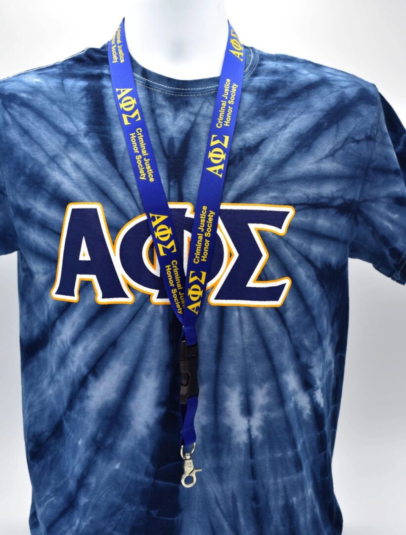 Blue tie-dye shirt with Greek letters.