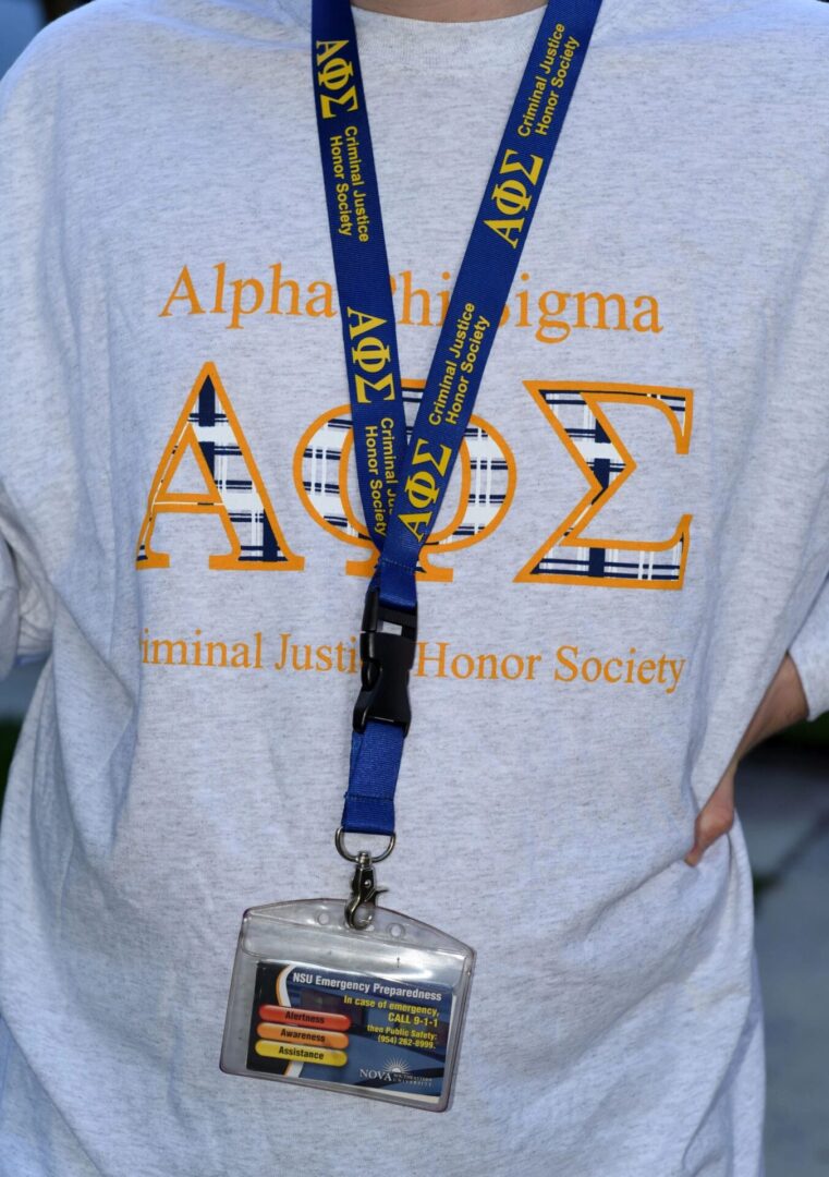 Person wearing society t-shirt and lanyard badge.