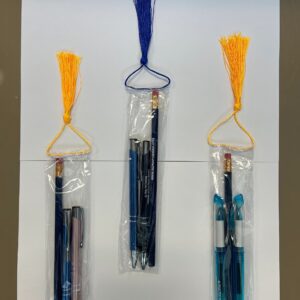 Three pen sets with tassels on display.