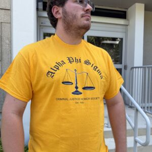 Man in yellow Alpha Phi Sigma t-shirt